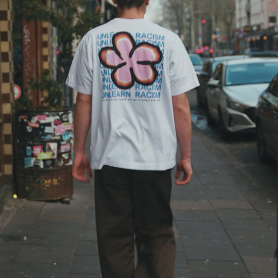 man walking in clouwsi flower shirt