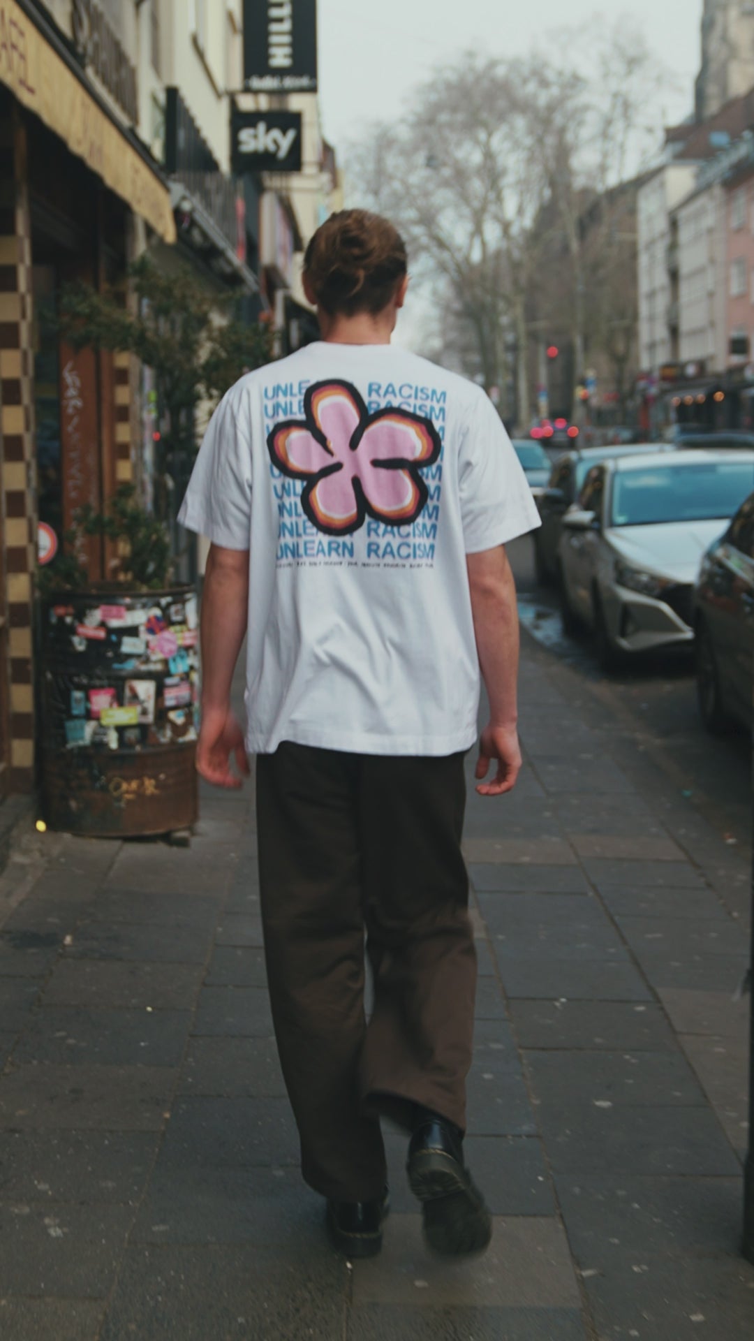 man walking in clouwsi flower shirt